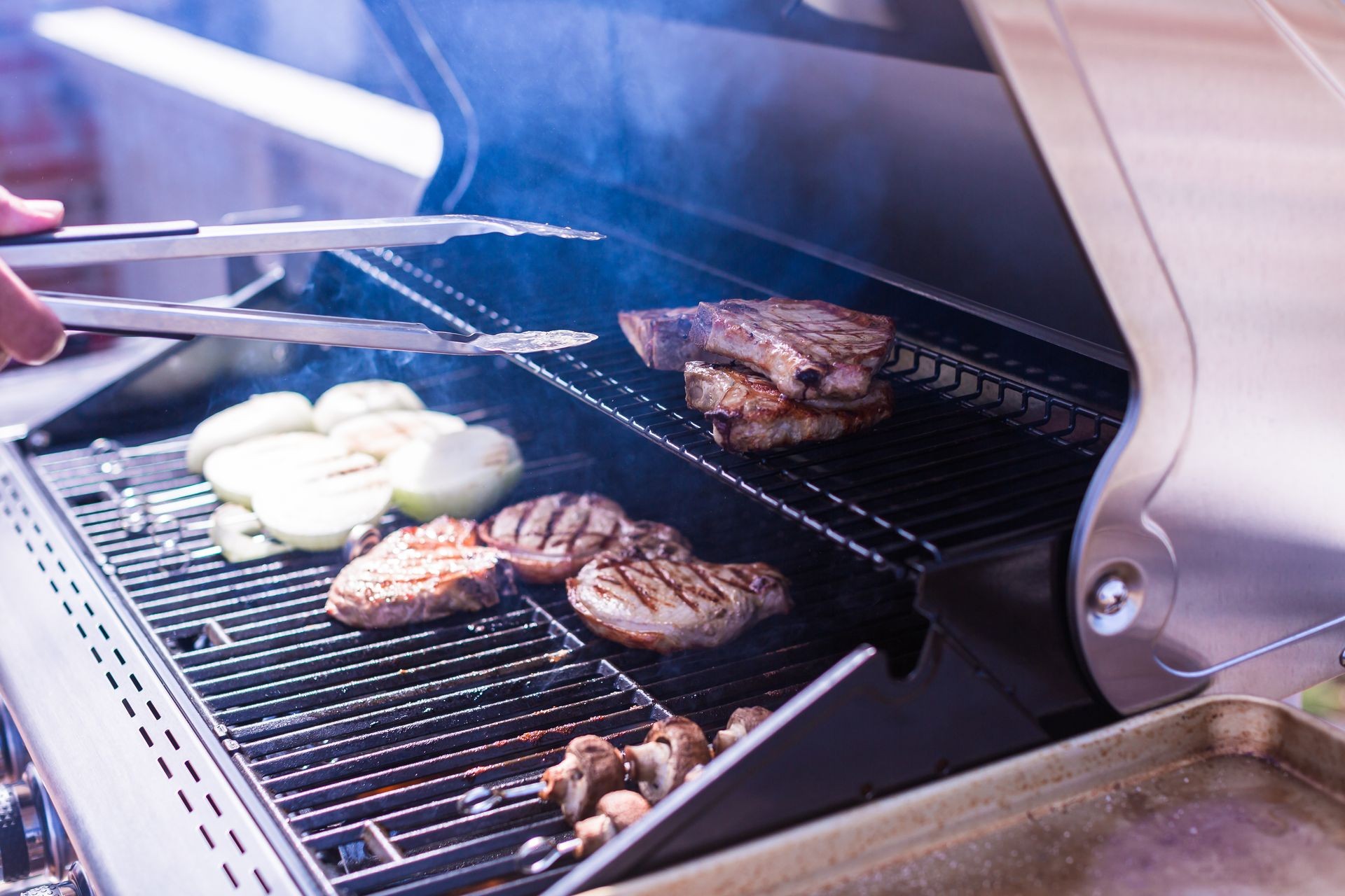 Grilling pork chops on gas grill in the Summer.